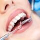 Child receiving a dental checkup with dental tools in mouth.